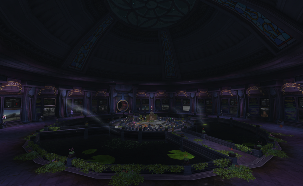 A view of the dark interior of the tapestry of time building showing the gift area in the center and ten panels for ten of Second Life's 19 years.