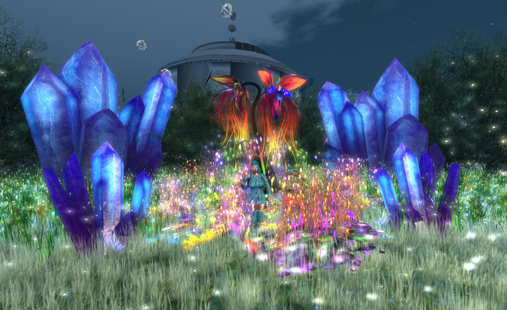 In a field of bright, tall grass, several clusters of glowing blue crystals rise 1 to 2 meters from the ground. In the middle of these, a thicket of brightly coloured luminous plants grows above the grass. A woman wearing a cyan outfit stands amongst these plants. Behind her, a tall plant grows a couple of meters high. It has orange fronds that drop from two stalks, fading to yellow at their ends. Three leaved pink-orange flowers top the display.