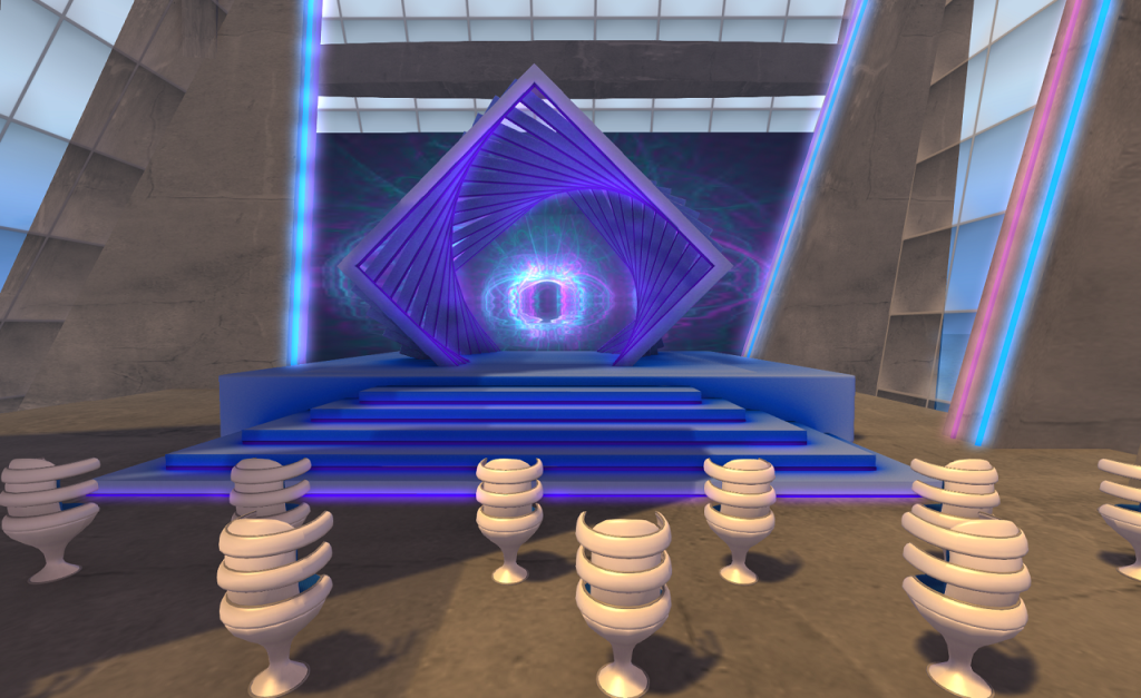 Nine highly stylized chairs sit in the foreground in a large concrete room. The left and right walls of the room are glass and blue sky can be seen through them. Directly in front of the chairs is a blue stage with six steps ascending to it built in large square platforms of diminishing size. The backdrop for the stage is a diagonally oriented square frame, perhaps 3 meters high. A dozen more such frames are inset and rotated forming a spiraling pattern. In the center is a light sculpture with blue and purple lobes surrounding a central void.