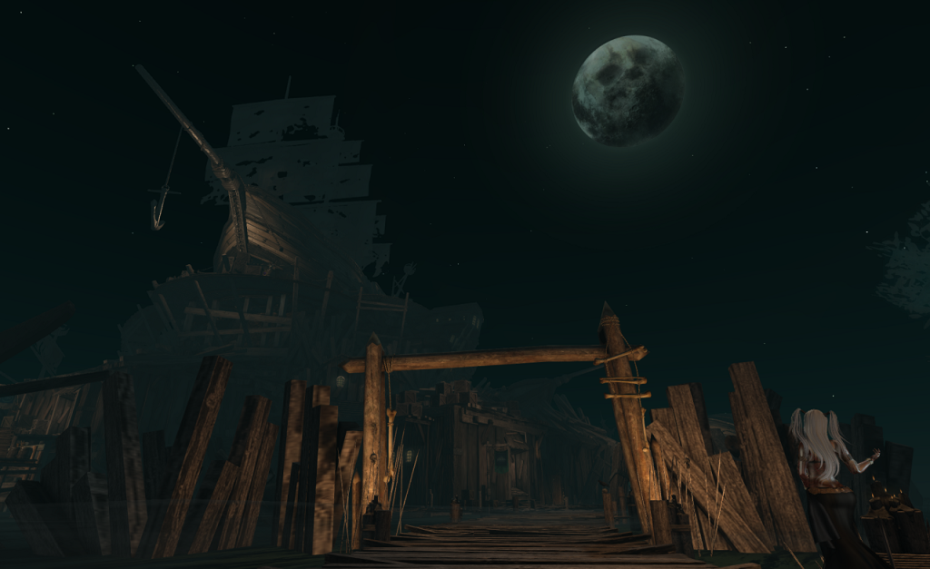 A rough boardwalk recedes from the lower center of the image into the middle distance, passing through a timber gate. Sharp spikes are planted around the uprights on either side of the gate. Skulls, ladders with rungs made from bones, and stumps with dimly glowing candles also adorn the entrance. On either side of the gate is a wall made from slapdash weathered planks. In the distance, above the gateway, a large wooden shipwreck is perched a rise, its tattered sails visible only in silhouette. An anchor dangles from its prow. Above all, a moon with a sinister skull like appearance hangs in a dark sky. 